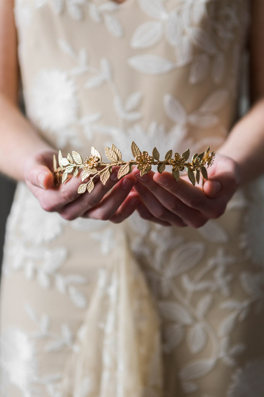 Bride wearing a gold leaf vine headband