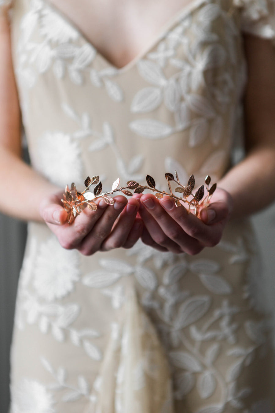 Bride wearing a delicate rose gold leaf tiara