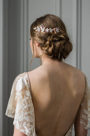 Bride wearing a rose gold and crystal bridal hair comb.