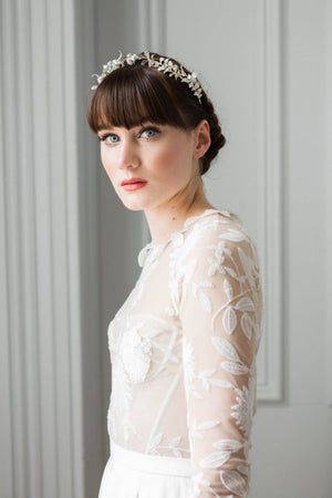 a bride wearing a gold headpeice made of silver myrtle leaves