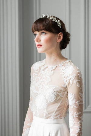 a bride wearing a gold headpeice made of silver myrtle leaves