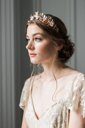 A bride wearing a gold laurel leaf flower crown