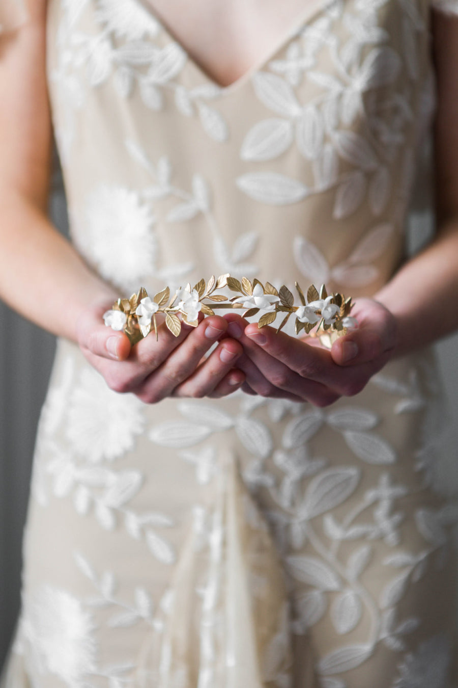 Bride wearing a crown heapiece made of gold leaves and silk flowers