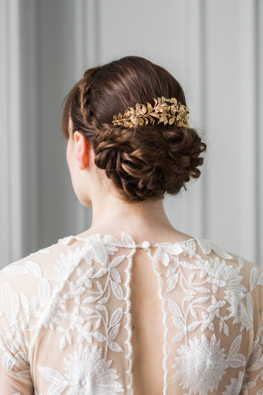 Model wearing a bridal hair comb made of gold leaves
