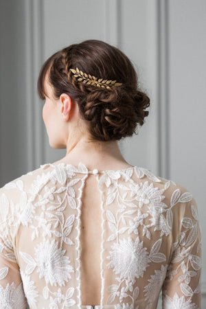 A bride wearing a gold edwardian leaf hair comb