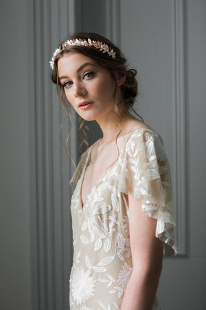 Bride wearing a rose gold tiara with silk flowers