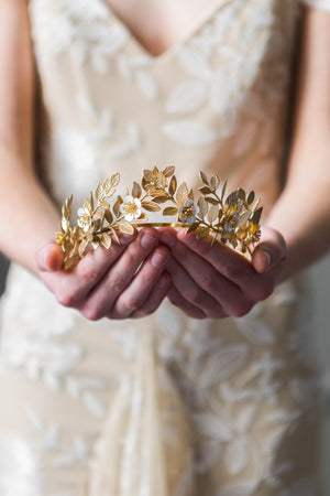 Bride holding a gold laurel leaf flower crown