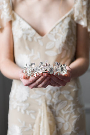 Bride holding a silver laurel leaf flower crown