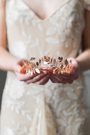 Bride holding a rose gold laurel leaf tiara