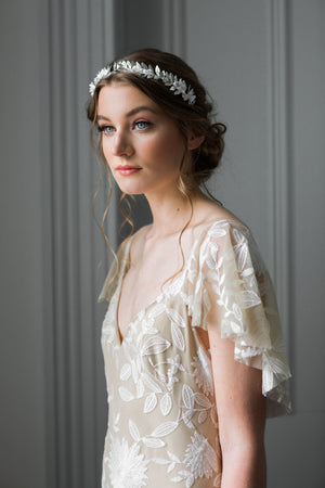 Bride wearing a gold tiara with silk flowers