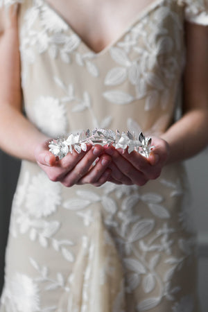 Bride wearing a silver tiara with silk flowers