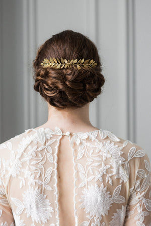 Bride wearing a gold leaf comb in an up do