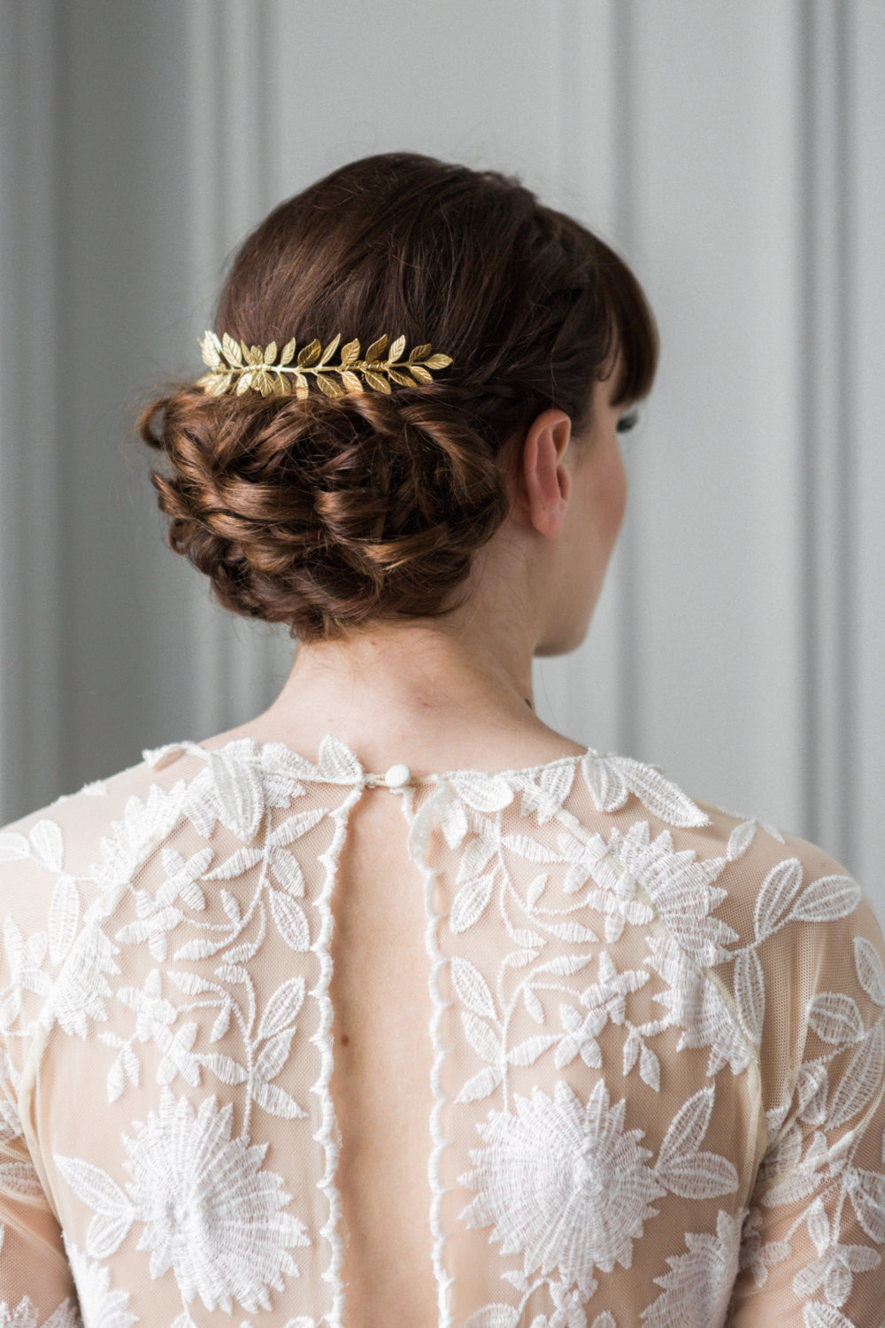 Bride wearing a gold leaf comb in an up do