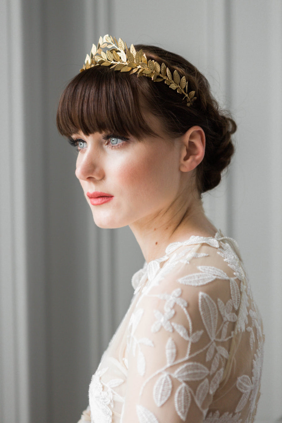 bride in a wedding dress wearing a gold leaf tiara