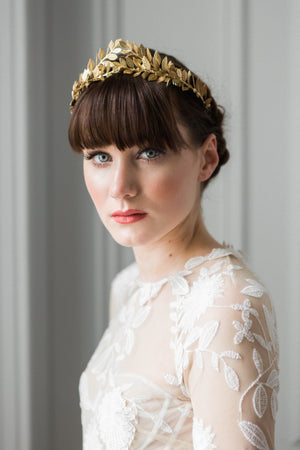 bride in a wedding dress wearing a gold leaf tiara
