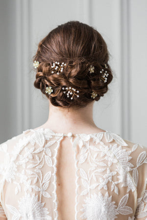 Model with babies breath hair pins in wedding dress