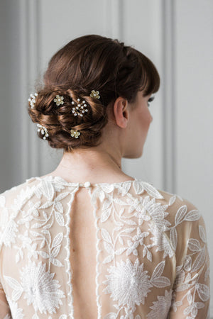 Model with babies breath hair pins in wedding dress