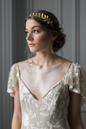 A bride wearing a delicate gold leaf tiara