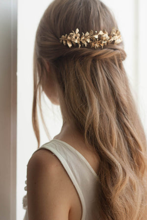 Model wearing a bridal headpiece made of gold myrtle leaves