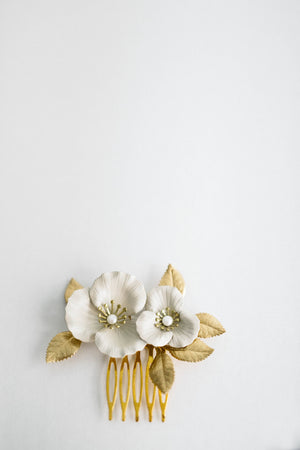 Close up of a hair comb made of gold and ivory flowers