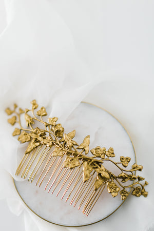 Close up of a hair comb headpiece made of gold leaves