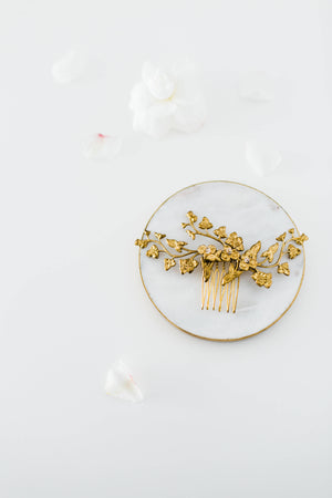 Close up of a bridal headpiece made of gold leaves and flowers