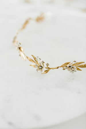 Close up of a gold and crystal bridal tiara