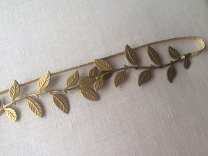 Close up of a garter made of brass laruel leaves